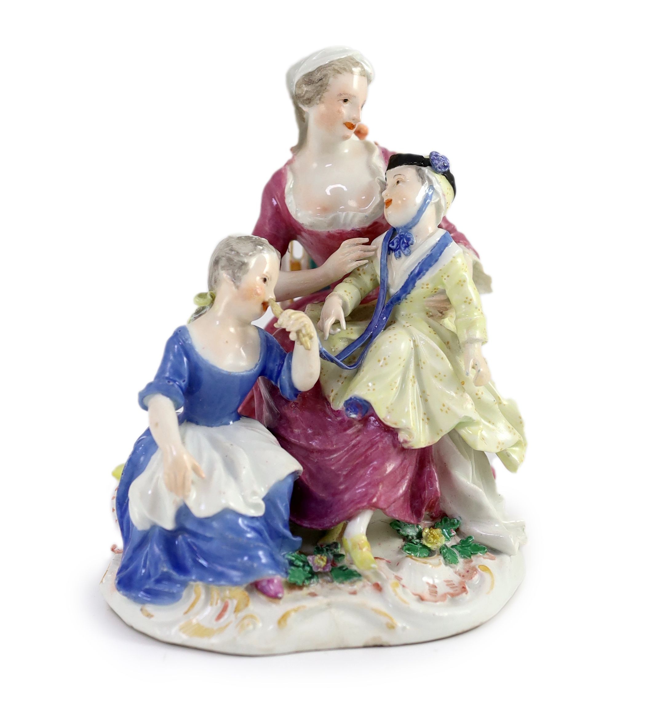 A Meissen group of a seated lady and two children, mid 18th century 16cm high, restored